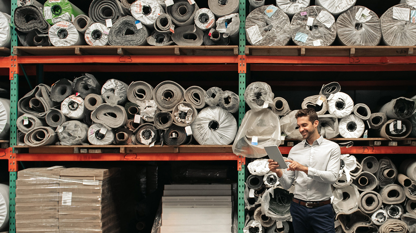 man standing in front of supply shelves