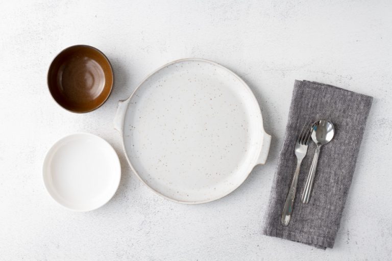 empty white plate and brown bowl on white table
