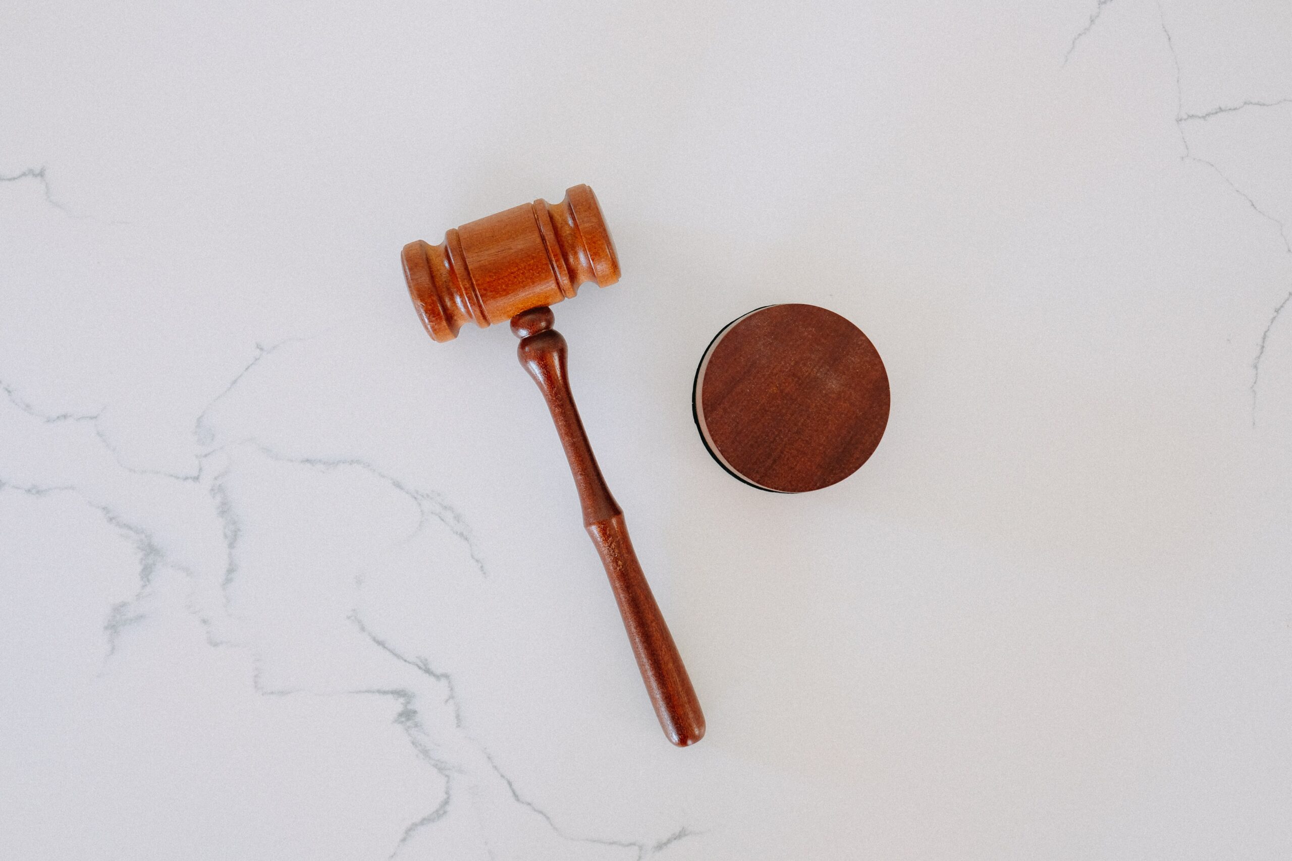 wood gavel on white marble table