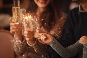 Happy family with sparklers and champagne celebrating.