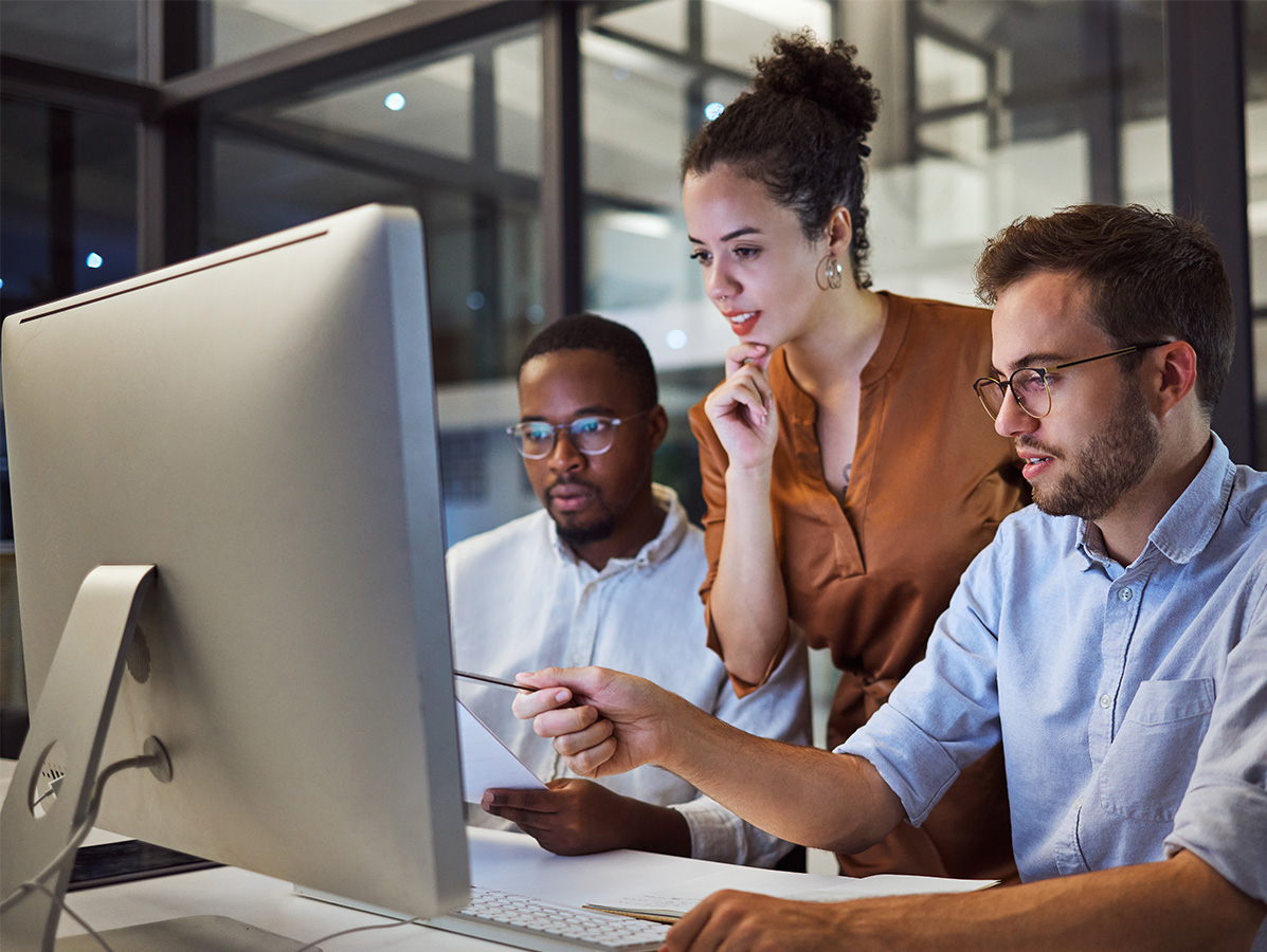 team of office workers looking at computer screen