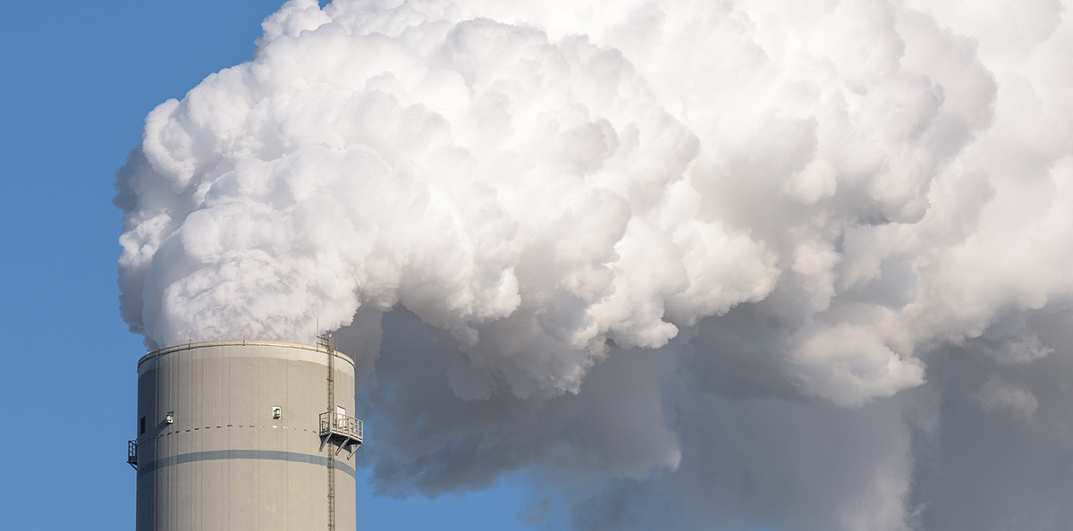 factory smoke stack adding carbon pollution to environment